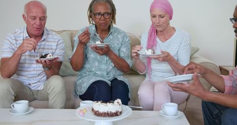Senior Friends Enjoying Cake and Coffee Together at Home