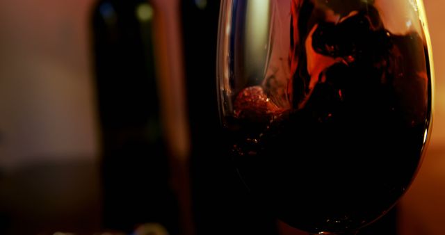 Close-up of Flowing Red Wine in Glass at Warm Dramatic Lighting - Download Free Stock Images Pikwizard.com