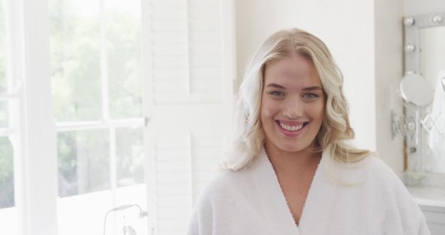 Smiling Woman in Bathrobe Enjoying Morning Routine in Bright Bathroom - Download Free Stock Images Pikwizard.com