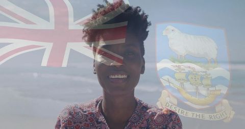 Smiling woman on beach with union jack and coat of arms overlay