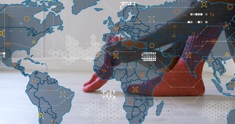 Red socks resting on pale wooden floor with global geospatial data and tech overlay
