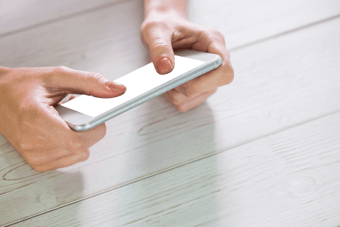 Hands typing on smartphone transparent background