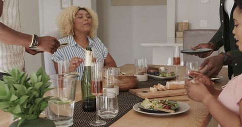Friends Sharing Laughter and Snacks in Cozy Home Setting