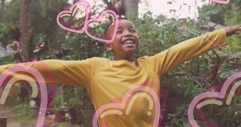 Joyful Boy Embracing Nature with Heart Overlays in Vibrant Garden