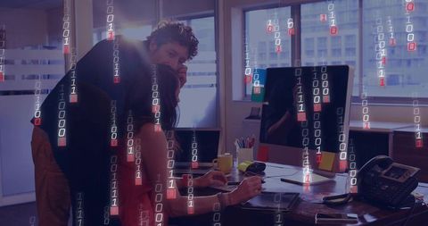 Coworkers collaborating in office with binary code technology theme