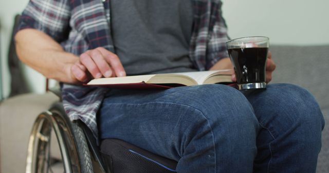 Person Reading Book on Wheelchair while Holding Coffee - Download Free Stock Images Pikwizard.com