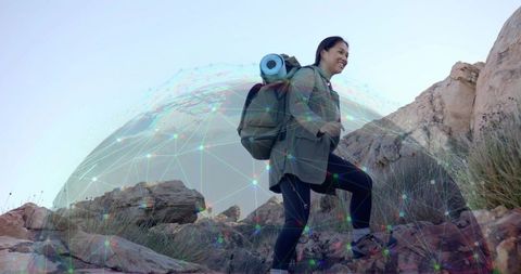Hiking Woman Climbing Rocky Terrain with Digital Overlay Sphere