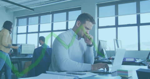 Businessman Analyzing Data on Laptop with Overlay Graph