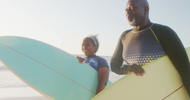 Senior African American Couple with Surfboards Enjoying Beach Sunset - Download Free Stock Images Pikwizard.com