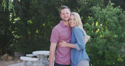 Happy Couple Embracing in Garden Setting
