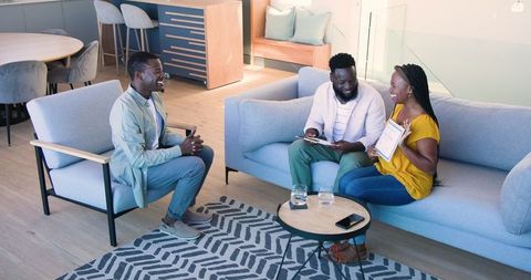 Couple Engaging in Counseling Session with Therapist in Modern Living Room