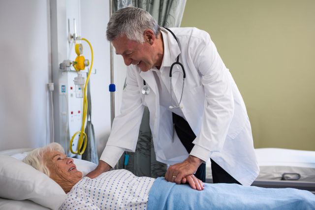 Doctor examining senior patient in hospital ward. Ideal for use in healthcare, medical, and elderly care contexts. Useful for illustrating medical checkups, patient care, and hospital environments.