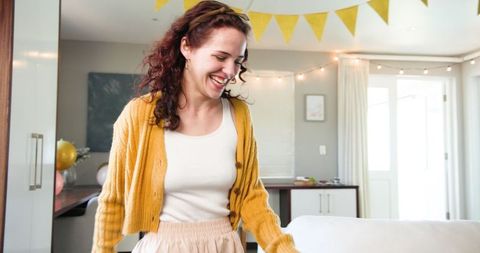 Joyful Woman Preparing for Birthday Party Flying Balloons and Decorations