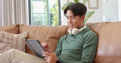 Young Man Enjoying Relaxed Lifestyle with Technology Indoors