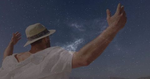 Man Embracing Night Sky Under Milky Way Galaxy