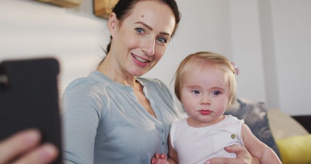 Caucasian mother taking a selfie with her baby on smartphone at home - Download Free Stock Photos Pikwizard.com