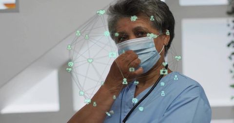 Mature Nurse Adjusting Mask in Clinic with Telehealth Network Overlay and Holographic Visualization