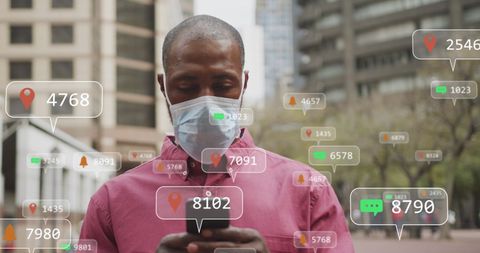 Man in Mask Engaged with Digital Interface Surrounded by Data Icons