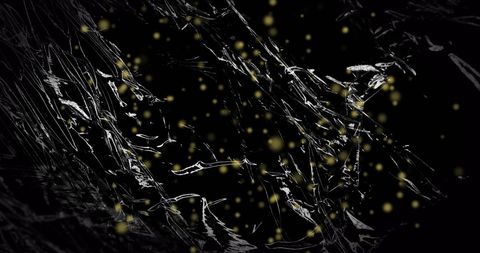Abstract black plastic with floating yellow particles