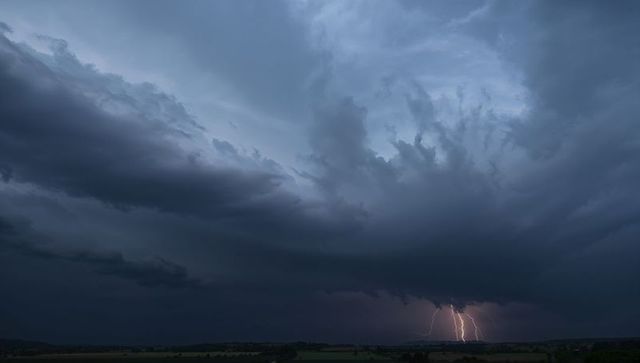 Spectacular Lightning Storm Over Darkened Fields at Dusk
