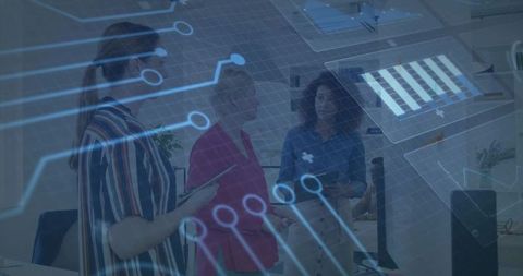 Businesswomen Collaborating with Circuit Overlay in Modern Office