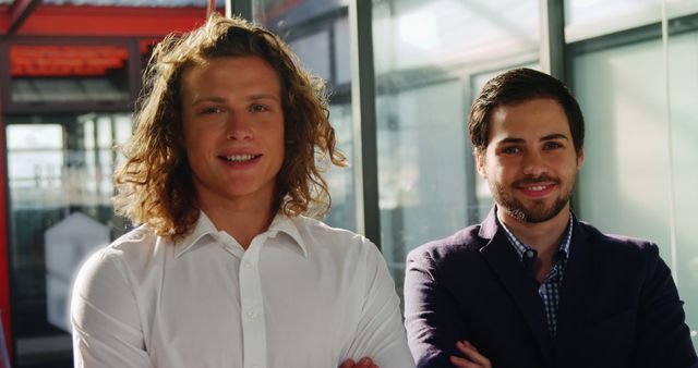 Two Young Men Smiling in Modern Office Environment - Download Free Stock Images Pikwizard.com