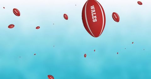 Floating Rugby Balls with Wales Text Against Blue Sky