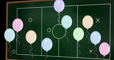 Colorful Balloons Over Strategic Game Plan Blackboard