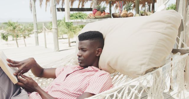 Young Man Relaxing on Tropical Beach Hammock Reading Book - Download Free Stock Images Pikwizard.com