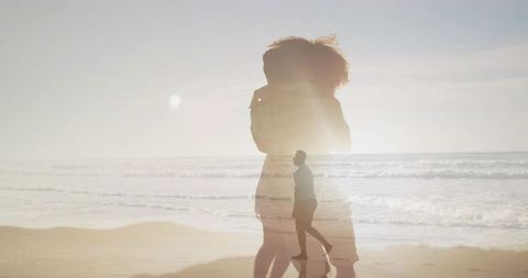 Dreamlike double exposure of woman silhouette and man walking on sunlit beach