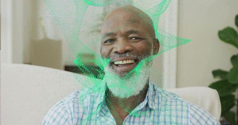 Senior Man Engaging with Holographic Projection at Home