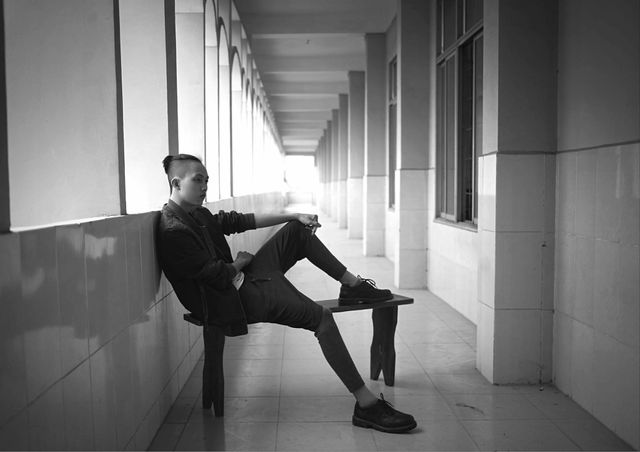 Young Man Relaxing in Corridor with Arched Walkway - Download Free Stock Photos Pikwizard.com