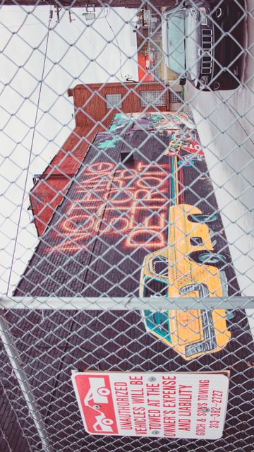 Urban Street Art Mural Behind Chain-Link Fence with Parked Cars - Download Free Stock Images Pikwizard.com