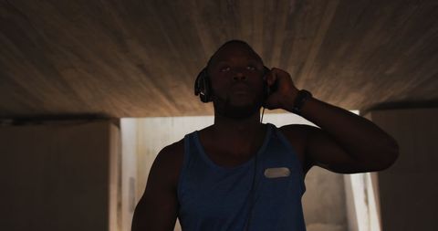 Athletic Man Relaxing Under Bridge with Headphones - Download Free Stock Images Pikwizard.com