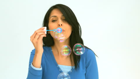 Woman Blowing Soap Bubbles with Bubble Wand