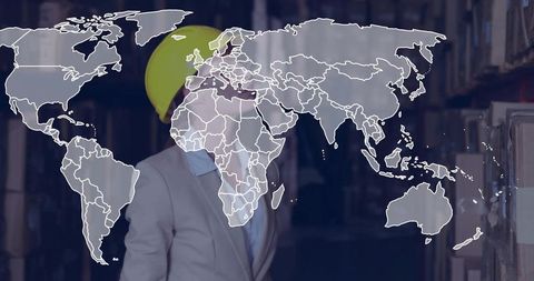 Female warehouse supervisor in hard hat inspecting inventory with global logistics map