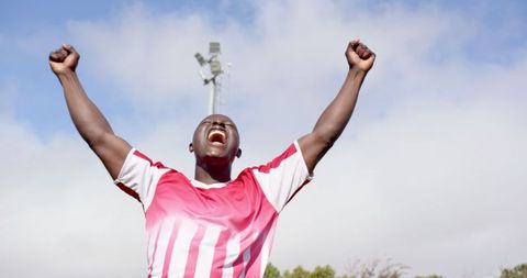 Excited Football Player Celebrating Victory on Field
