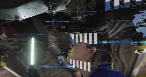 Female Technician Inspecting Undercarriage Holding LED Light With AR Vehicle Diagnostics