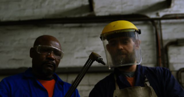 Metalworkers in Protective Gear Using Welding Torch in Industrial Workshop - Download Free Stock Images Pikwizard.com