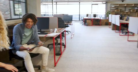 Colleagues discussing project planning in modern office environment