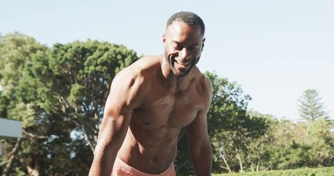 Mature athletic man smiling after swim showing fitness graph overlay on torso