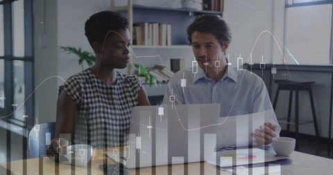Colleagues reviewing financial charts on laptop, collaborative analytics and teamwork
