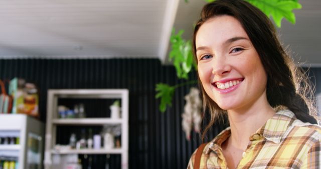 Smiling Woman in Coffee Shop with Plant in Background - Download Free Stock Images Pikwizard.com