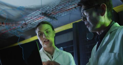 Engineers Analyzing Data in High-Tech Server Room with World Map Overlay - Download Free Stock Images Pikwizard.com
