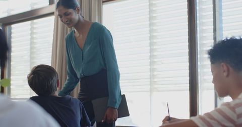 Asian Indian Teacher Encouraging Students in Classroom Setting