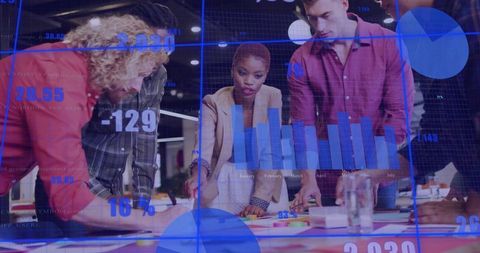 Diverse Team Analyzing Data with Graphs and Charts in Modern Office