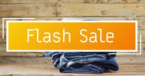 Flash sale promotion with denim jeans on wooden background