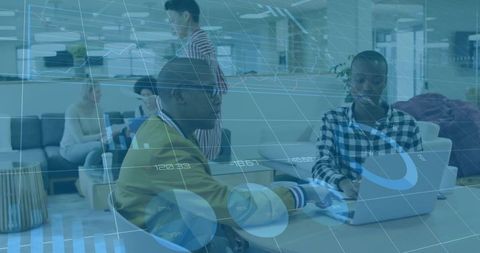 Collaborating on laptop with digital data overlays in modern coworking lounge workspace
