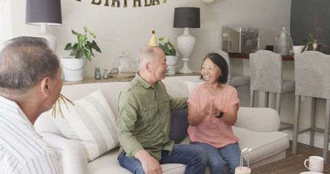 Elderly Couple Celebration with Family in Cozy Living Room