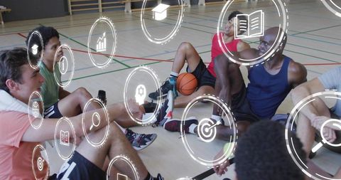 Huddling basketball team planning plays on gym floor with augmented analytics overlay